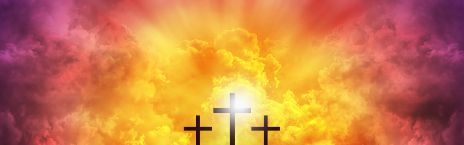 Image of three crucifixion crosses against a bright sunrise sky